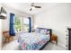 Bright bedroom with plush carpet, ceiling fan and a view of the outdoors at 2156 Antilles Club Dr, Kissimmee, FL 34747