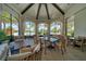 Elegant clubhouse area with high ceilings, ceiling fans, dining tables and chairs, and large windows showcasing the pool area at 2156 Antilles Club Dr, Kissimmee, FL 34747