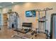 Well-equipped gym featuring weight machines, dumbbells, and a wall-mounted television at 2156 Antilles Club Dr, Kissimmee, FL 34747
