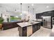 Open-concept kitchen with a large island, stainless steel appliances, and seamless flow to the living area and pool at 2156 Antilles Club Dr, Kissimmee, FL 34747