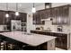 Well-equipped kitchen with granite countertops, stainless steel appliances, and island with seating, great for cooking and socializing at 2156 Antilles Club Dr, Kissimmee, FL 34747