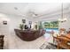 Open-concept living area with a large sectional sofa and views of the screened-in pool at 2156 Antilles Club Dr, Kissimmee, FL 34747