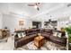 Spacious living room featuring a large leather sectional sofa, and an open layout to the modern kitchen at 2156 Antilles Club Dr, Kissimmee, FL 34747