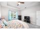 Bright main bedroom featuring a tray ceiling, plush carpeting, and a view of the pool at 2156 Antilles Club Dr, Kissimmee, FL 34747