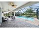 Relaxing screened-in pool patio with ceiling fans and comfortable seating area for outdoor enjoyment at 2156 Antilles Club Dr, Kissimmee, FL 34747