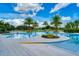 Resort-style pool with mature palm trees, sun loungers, and a bright blue sky at 2156 Antilles Club Dr, Kissimmee, FL 34747