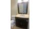 Bathroom featuring a dark vanity with light marble countertop and a framed mirror at 2233 N Normandy Blvd, Deltona, FL 32725