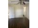 Bedroom with wood floors and a ceiling fan; doorway visible to the bathroom at 2233 N Normandy Blvd, Deltona, FL 32725