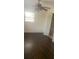 Bedroom with wood floors, ceiling fan, and a window with blinds for natural light at 2233 N Normandy Blvd, Deltona, FL 32725