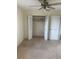 Bedroom featuring neutral carpet and an open closet with double doors at 2233 N Normandy Blvd, Deltona, FL 32725