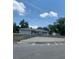 Single story home with gray siding, light colored roof, white railing, and a partial view of the front yard at 2233 N Normandy Blvd, Deltona, FL 32725