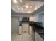 Bright kitchen with white cabinets, black countertops, stainless steel microwave, and tiled backsplash at 2233 N Normandy Blvd, Deltona, FL 32725
