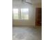 Bright living room with large windows, ceiling fan, and a neutral color palette at 2233 N Normandy Blvd, Deltona, FL 32725