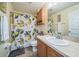Cozy bathroom featuring lemon shower curtain and wooden cabinets at 2354 Barons Ct, Tavares, FL 32778