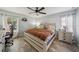 Well-lit bedroom featuring wood-look flooring, neutral walls, and a cozy atmosphere at 2354 Barons Ct, Tavares, FL 32778