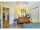 Bedroom featuring laminate floors, white trim, and closet storage at 2354 Barons Ct, Tavares, FL 32778