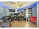 Bedroom featuring laminate floors, a ceiling fan, and blue LED lights at 2354 Barons Ct, Tavares, FL 32778