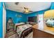 Bright bedroom features blue walls, ceiling fan and laminate flooring at 2354 Barons Ct, Tavares, FL 32778