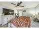 Cozy bedroom with wood-look floors, a ceiling fan, and a bright window creating a relaxing space at 2354 Barons Ct, Tavares, FL 32778