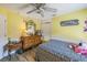 Bedroom with laminate floors, a ceiling fan, and playful décor at 2354 Barons Ct, Tavares, FL 32778