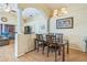 Dining room with stylish chandelier, hardwood floors and architectural columns that give an open feel to the space at 2354 Barons Ct, Tavares, FL 32778