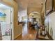 Hallway leading to open living and dining spaces, showcasing the home's layout and design at 2354 Barons Ct, Tavares, FL 32778