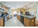 Open kitchen with a large island, stainless steel appliances, and a view into the dining and living areas at 2354 Barons Ct, Tavares, FL 32778