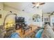 Bright living room featuring hardwood floors, a ceiling fan, and an archway leading to another room at 2354 Barons Ct, Tavares, FL 32778