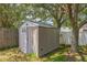 Outdoor storage shed with a door and window providing practical backyard storage space at 2354 Barons Ct, Tavares, FL 32778