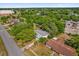 Aerial view of a home with mature landscaping, large trees, and a metal roof in a developed neighborhood at 2357 E Dana Dr, Deltona, FL 32738