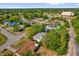 Aerial view of homes in a mature neighborhood with lush landscaping, and in close proximity to a neighborhood church at 2357 E Dana Dr, Deltona, FL 32738