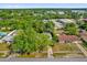 Aerial view of a home with mature landscaping, including large shade trees, in a quiet residential neighborhood at 2357 E Dana Dr, Deltona, FL 32738
