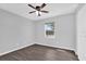A bedroom with hard wood floors, ceiling fan, and a window at 2357 E Dana Dr, Deltona, FL 32738