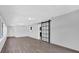 Bonus room showcasing a barn door and hardwood floors at 2357 E Dana Dr, Deltona, FL 32738