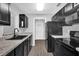Updated kitchen with dark cabinets, stone countertops, and stainless steel appliances at 2357 E Dana Dr, Deltona, FL 32738