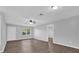 Cozy living room with a window, ceiling fan, and wood-look flooring at 2357 E Dana Dr, Deltona, FL 32738