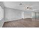 Bright living room featuring stylish wood-look flooring and a modern ceiling fan at 2357 E Dana Dr, Deltona, FL 32738
