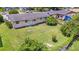 Aerial view of the property showing a large backyard with mature trees at 245 Amador Cir, Orlando, FL 32810