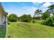 Spacious backyard with lush green grass and mature trees at 245 Amador Cir, Orlando, FL 32810