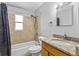 This bathroom boasts a shower-tub combo and a granite countertop vanity at 245 Amador Cir, Orlando, FL 32810