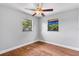 Bedroom with ample natural light from two windows and wood flooring at 245 Amador Cir, Orlando, FL 32810