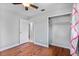 Bedroom showcasing beautiful wood floors, closet space, and an open doorway at 245 Amador Cir, Orlando, FL 32810