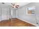 Bedroom showcasing wood floors, ceiling fan, and a bright window at 245 Amador Cir, Orlando, FL 32810
