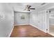 This bedroom features a ceiling fan and hard wood floors at 245 Amador Cir, Orlando, FL 32810
