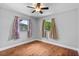 This bedroom features a ceiling fan and hard wood floors at 245 Amador Cir, Orlando, FL 32810