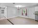 Open dining area with tile floors, natural light, and modern chandelier at 245 Amador Cir, Orlando, FL 32810