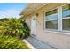Inviting front entrance with vibrant greenery and a white door, enhancing curb appeal at 245 Amador Cir, Orlando, FL 32810