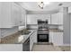 This kitchen features white cabinets, stainless steel appliances, and granite countertops at 245 Amador Cir, Orlando, FL 32810