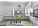 Bright kitchen showcases stainless sink and modern countertops with a view from the window at 245 Amador Cir, Orlando, FL 32810
