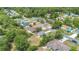 An overhead view of the home in a treed neighborhood with plenty of other single-Gathering homes at 250 Hickory Ave, Orange City, FL 32763